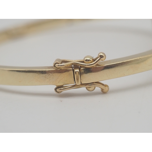 225 - A 9ct Yellow Gold Diamond Bangle, Set with round brilliant cut diamonds + Baguette Cut Diamonds, app... 