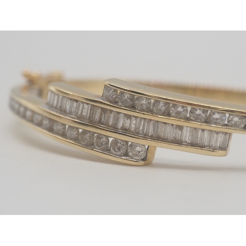 225 - A 9ct Yellow Gold Diamond Bangle, Set with round brilliant cut diamonds + Baguette Cut Diamonds, app... 