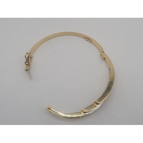 225 - A 9ct Yellow Gold Diamond Bangle, Set with round brilliant cut diamonds + Baguette Cut Diamonds, app... 