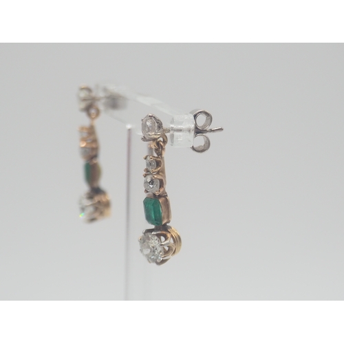 234 - A pair of mixed 18ct white and 14ct yellow gold emerald + diamond set drop earrings, size 23.3mm x 5... 