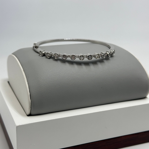 232 - An 18ct white gold diamond bangle,  approx 1.10ct in total each stone approx 0.10ct, 7 1/2 inches lo... 