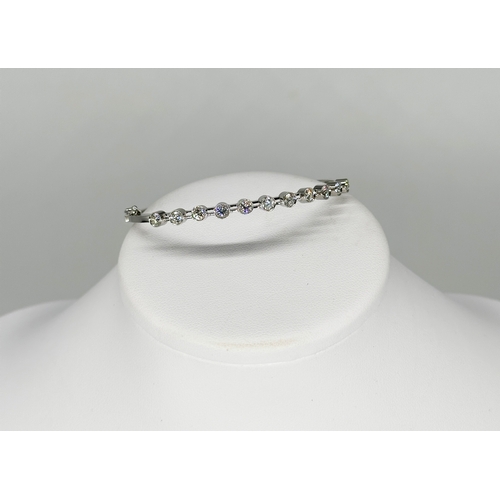 232 - An 18ct white gold diamond bangle,  approx 1.10ct in total each stone approx 0.10ct, 7 1/2 inches lo... 