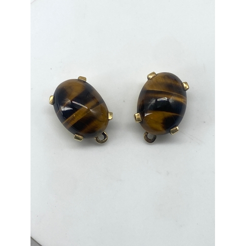 81 - A pair of 18ct yellow gold tigers eye drop earrings, the earrings drop wires will need replacing, no... 