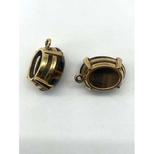 81 - A pair of 18ct yellow gold tigers eye drop earrings, the earrings drop wires will need replacing, no... 