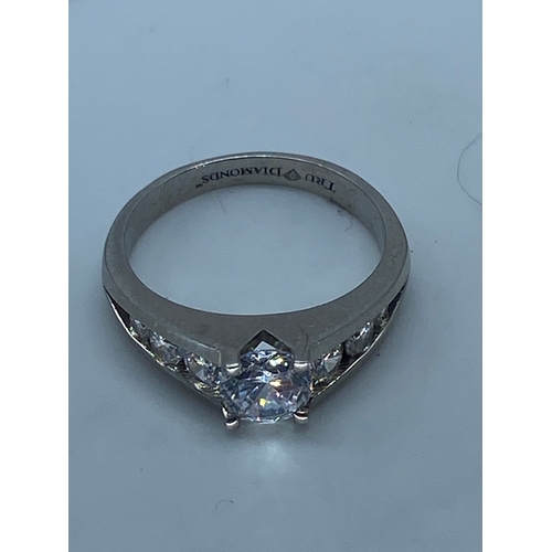 143 - A 9ct white gold cz stone set ring,
size R,
weight is 4.6 grams approx,
inside band engraved true di... 