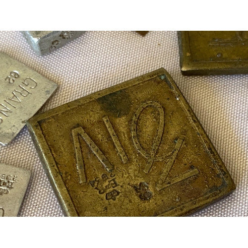121 - A collection of postal stamp weights