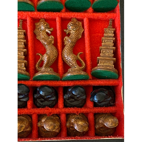 126 - An oriental carved chess set