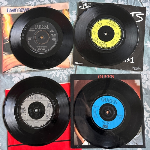 This collection comprises eight vintage 7-inch vinyl single records ...