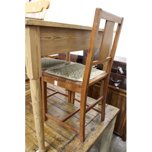 166 - A small pine table and a pair of oak chairs.