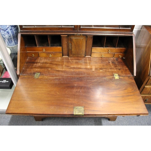 197 - A George III mahogany bureau with associated bookcase top.