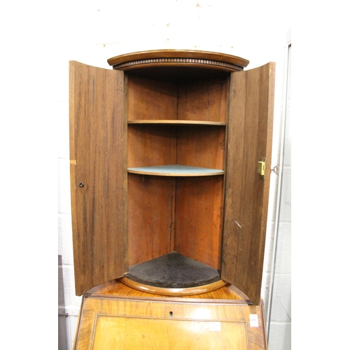 198 - A mahogany bow front hanging corner cupboard.