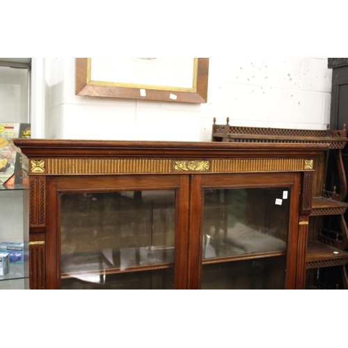 200 - A Victorian walnut two-door glazed bookcase (alterations).