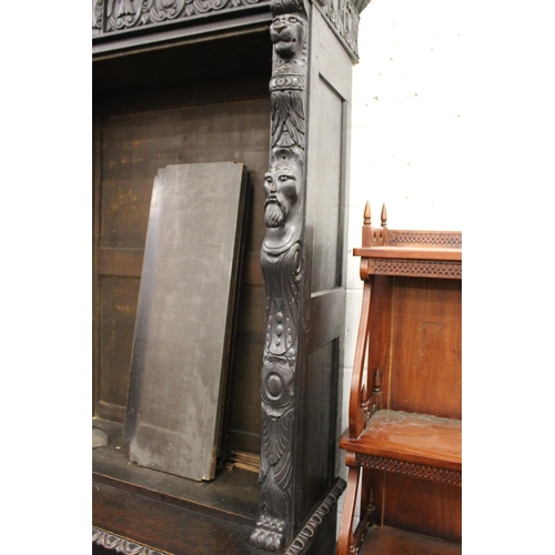 204 - A late Victorian Gothic Revival carved oak cupboard bookcase.