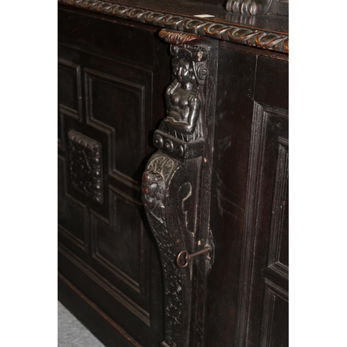 204 - A late Victorian Gothic Revival carved oak cupboard bookcase.