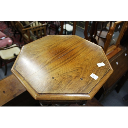 211 - A 19th century rosewood octagonal shaped work table on carved tripod base.