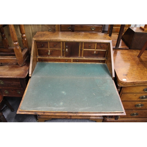 226 - A George III oak bureau with a drop flap, over a single drawer and pair of cupboard doors.