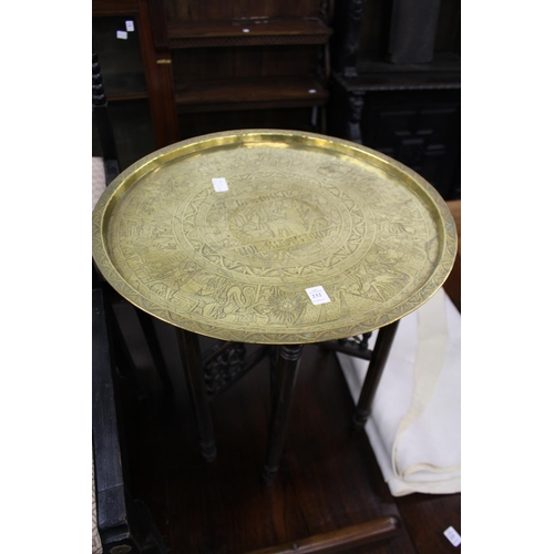 232 - An eastern engraved brass circular tray table.