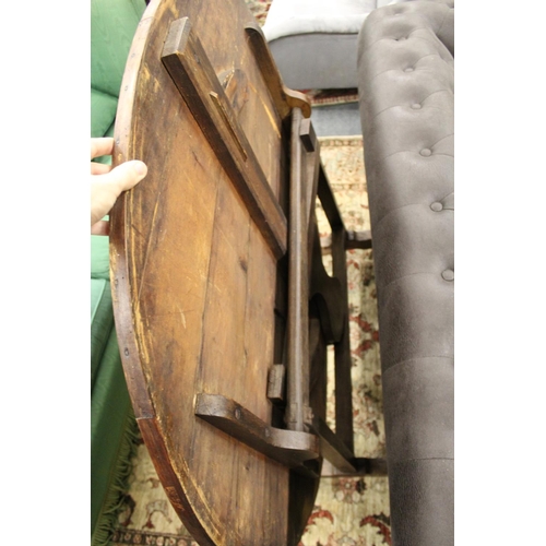 247 - A continental pine oval tilt top dining table.