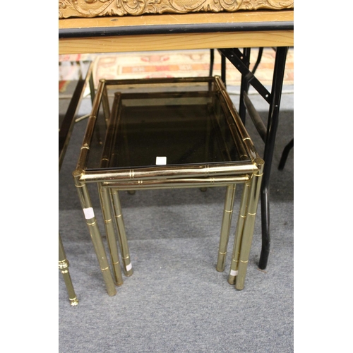 270 - A brass faux bamboo and smoked glass coffee table together with a matching nest of tables.