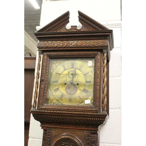 290 - An 18th century long case clock with square brass dial and carved oak case (alterations).