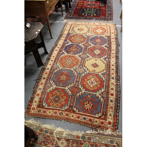 304 - A Persian rug with two rows of six medallions.