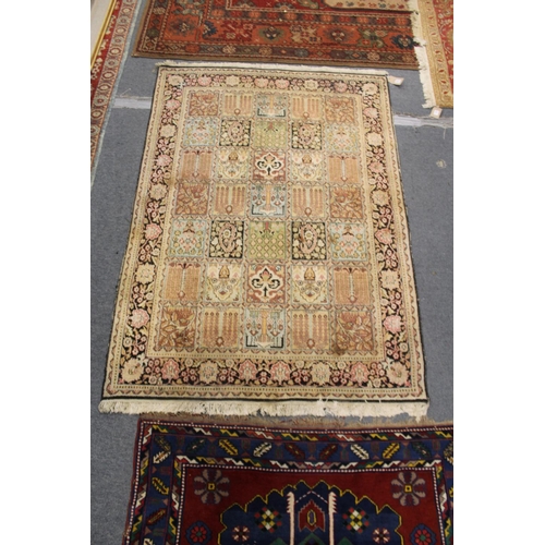 308 - A Persian rug, beige ground with five rows of seven square shaped decorative panels.