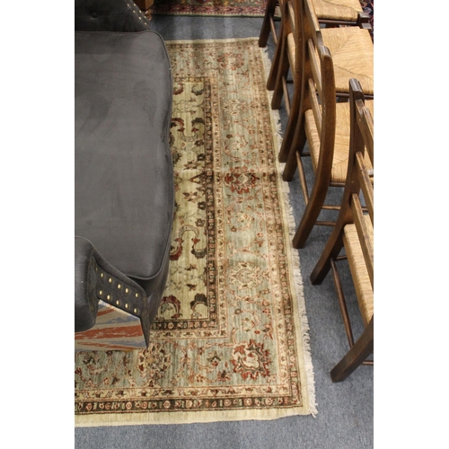 312 - A large Persian style carpet, beige ground with stylized decoration.