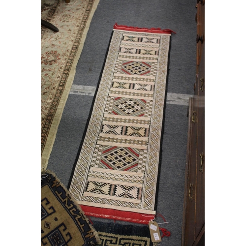 313 - Four small Persian style rugs.