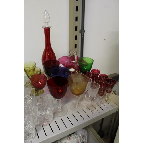 34 - Cut glass champagne glasses, colourful glassware etc.