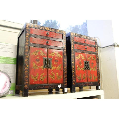 38 - A pair of Chinese decorative lacquer small cabinets with two drawers and two cupboard doors.