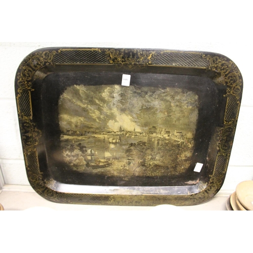 646 - A 19th century Toleware rectangular tray decorated with a river scene with buildings and sailing shi... 