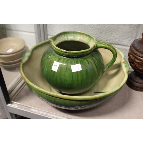 652 - An Arts and Crafts green glazed pottery jug and bowl set (chipped).