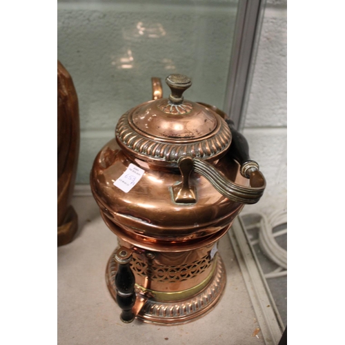 653A - A copper kettle on stand.