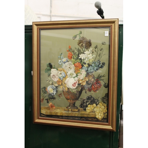 656 - A good silk work embroidered picture depicting flowers in a vase on a ledge, in a gilt frame.