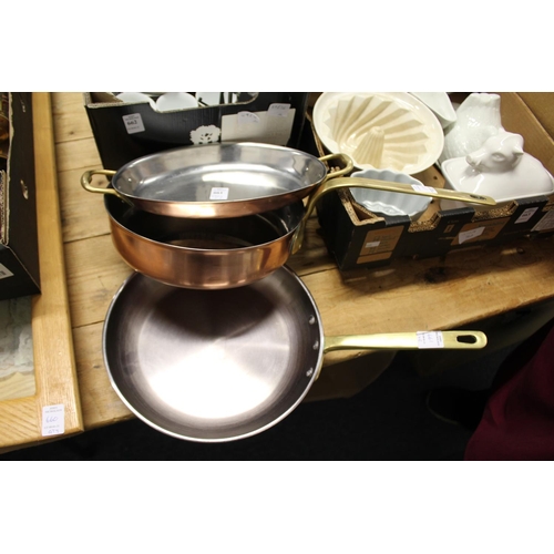 661 - Two good quality copper and brass frying pans and a similar twin handled dish.