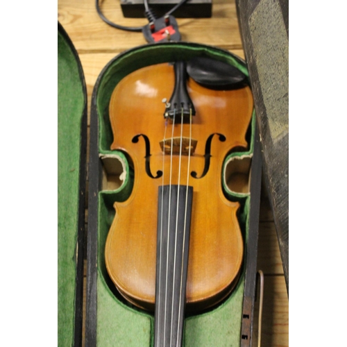 667 - Three violins, complete with cases.