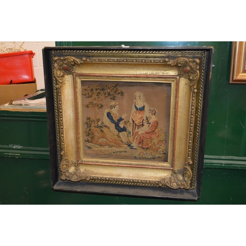 655 - A Victorian embroidered picture in a decorative frame.