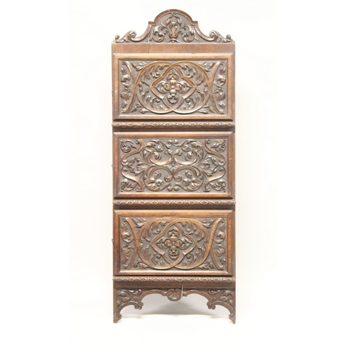 1009 - A LATE 19TH CENTURY WALNUT HANGING CORNER CUPBOARD, with profusely carved cresting and three similar... 