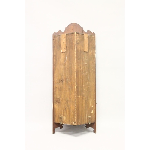 1009 - A LATE 19TH CENTURY WALNUT HANGING CORNER CUPBOARD, with profusely carved cresting and three similar... 