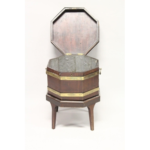 1010 - A GEORGE III MAHOGANY AND BRASS BOUND OCTAGONAL CELLARETTE , on tapering square legs. 1ft 8ins wide ... 