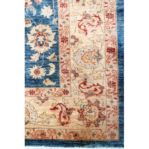 1042 - A ZIEGLER CARPET, 20th century, pale blue ground with stylised palmettes and floral decoration withi... 