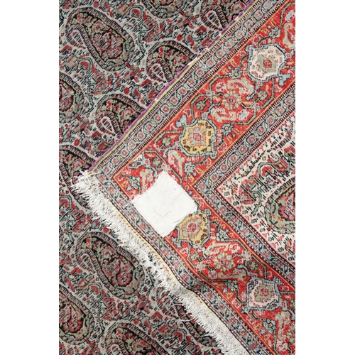 1043 - A PERSIAN SENNA RUG, early 20th century, beige ground with Boteh decoration within a red ground bord... 