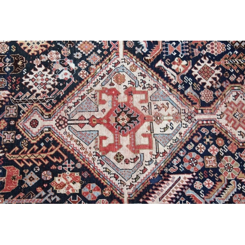 1044 - A PERSIAN QASHQAI RUG, early 20th century, dark blue ground with a central diamond shaped panel. 7ft... 