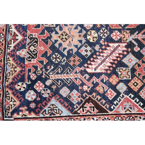 1044 - A PERSIAN QASHQAI RUG, early 20th century, dark blue ground with a central diamond shaped panel. 7ft... 