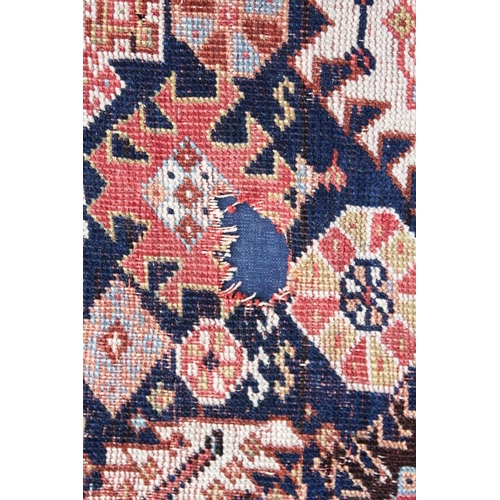 1044 - A PERSIAN QASHQAI RUG, early 20th century, dark blue ground with a central diamond shaped panel. 7ft... 