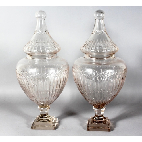 1060 - A GOOD LARGE PAIR OF CRYSTAL CUT SWEET JARS AND COVERS on square stepped bases. 21ins high.