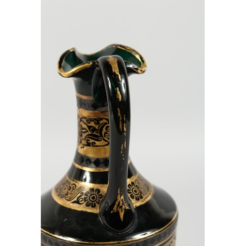 1062 - A CONTINENTAL DARK GREEN GLASS EWER AND STOPPER, with etched and gilded decoration. 14ins high.