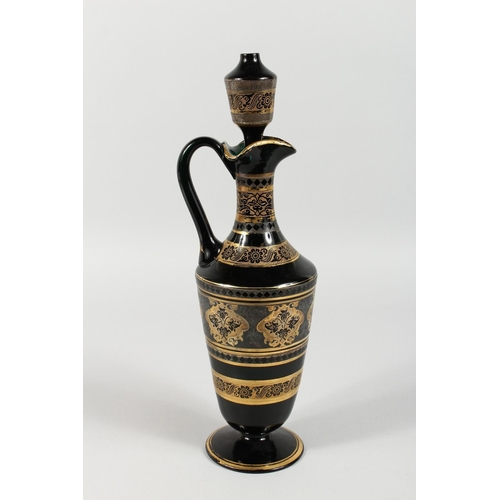 1062 - A CONTINENTAL DARK GREEN GLASS EWER AND STOPPER, with etched and gilded decoration. 14ins high.