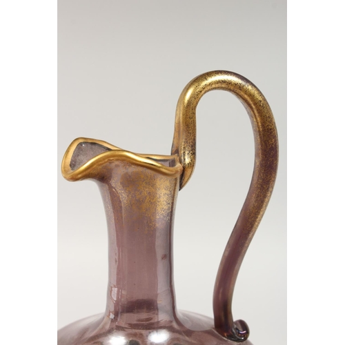 1066 - A VENETIAN AMETHYST TINTED GLASS EWER, with gilt and enamel decoration; together with the matching l... 