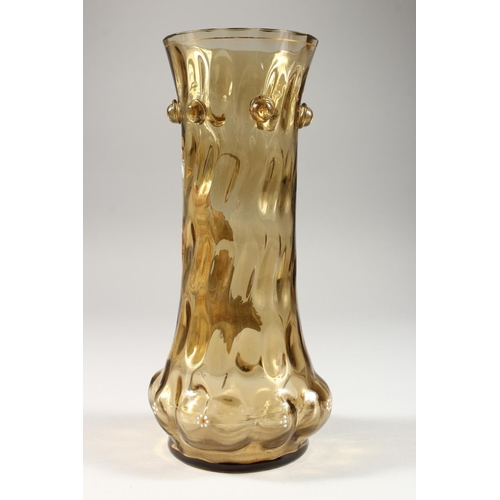 1067 - AN ITALIAN AMBER TINTED MOULDED GLASS VASE, enamel decorated with a classical figure. 10ins high.... 